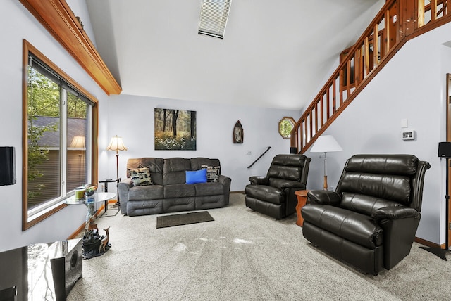 carpeted living area featuring visible vents, stairway, a high ceiling, and baseboards