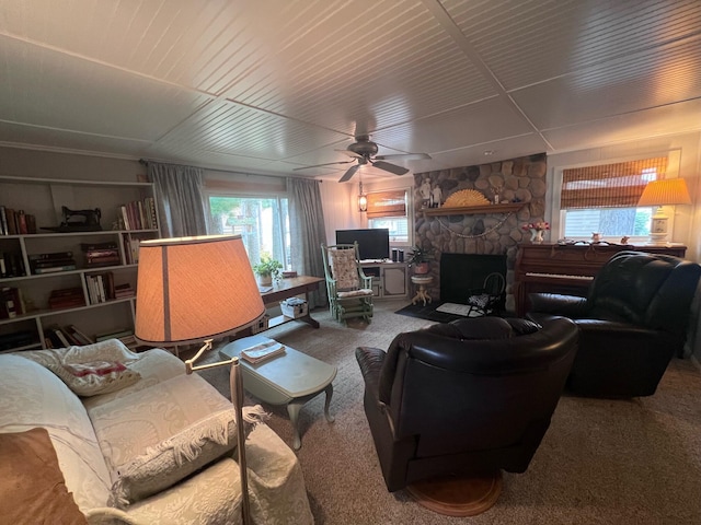 living room featuring carpet, ceiling fan, and a fireplace