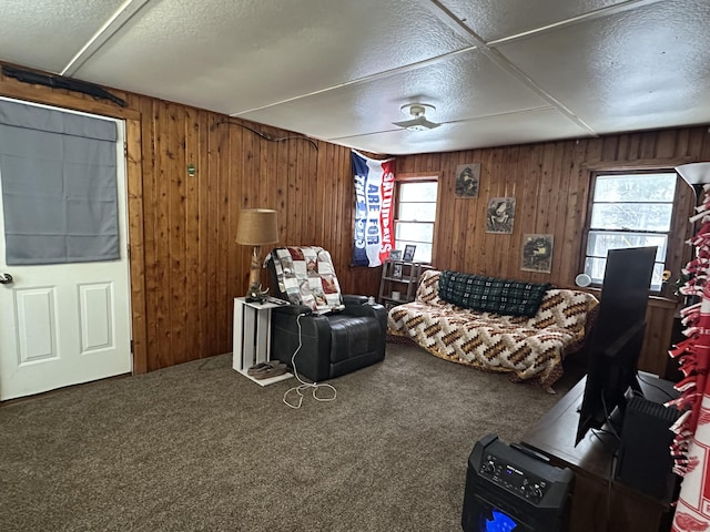 living room with a wealth of natural light, carpet flooring, and a textured ceiling