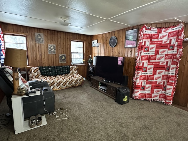 carpeted living room with wooden walls and a textured ceiling