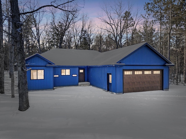 modern inspired farmhouse with a garage