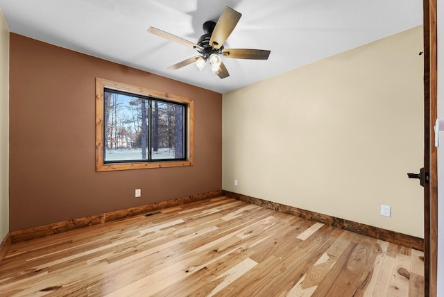 empty room with ceiling fan, visible vents, baseboards, and light wood-style flooring