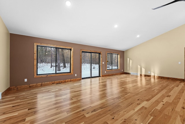 unfurnished living room featuring light wood finished floors, visible vents, recessed lighting, and baseboards