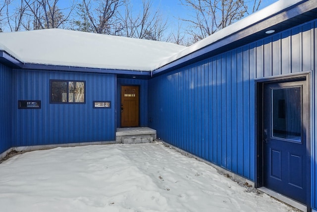 view of snow covered property entrance