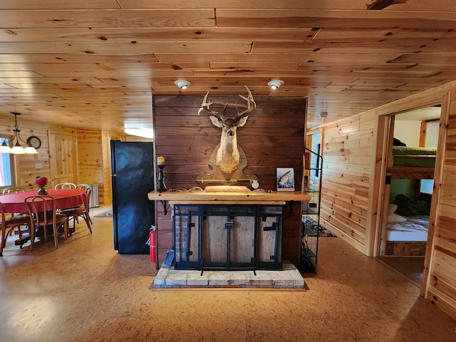 dining area featuring wood walls and wooden ceiling