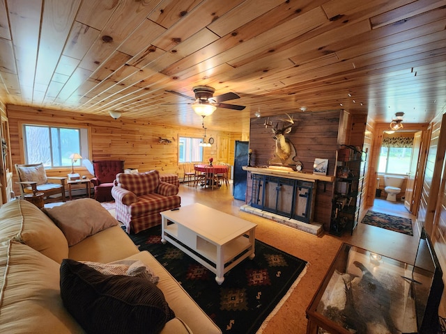 living room featuring plenty of natural light, wooden ceiling, and a ceiling fan