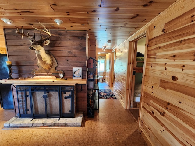 hallway with wood ceiling and wood walls