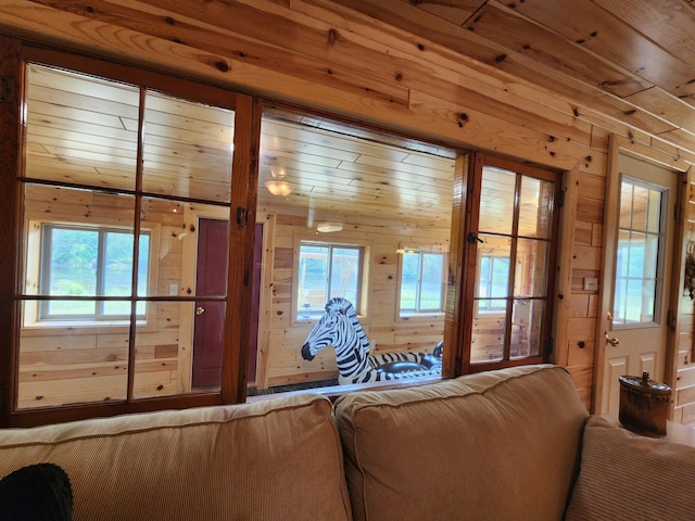 unfurnished living room featuring wood walls and wooden ceiling