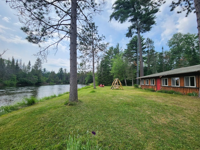 view of yard with a playground and a water view