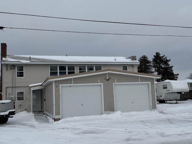 view of front of property featuring a garage and a chimney