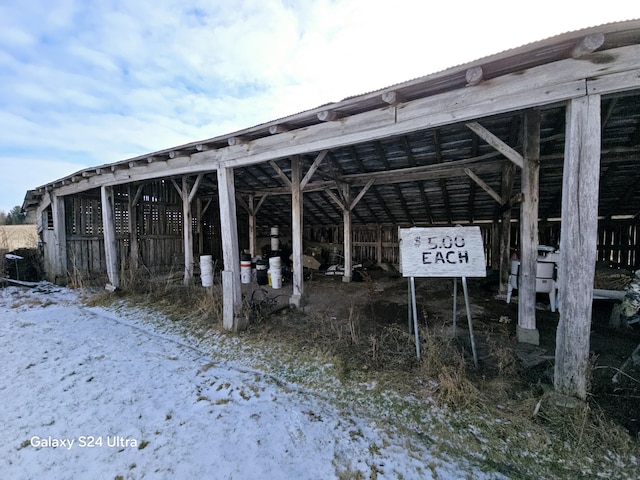 view of property's community featuring an outbuilding, a detached carport, and a pole building