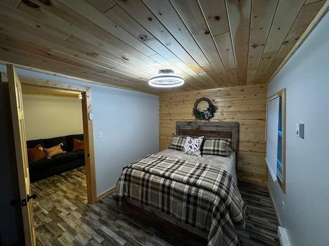 bedroom with wood finished floors, wooden walls, and wooden ceiling