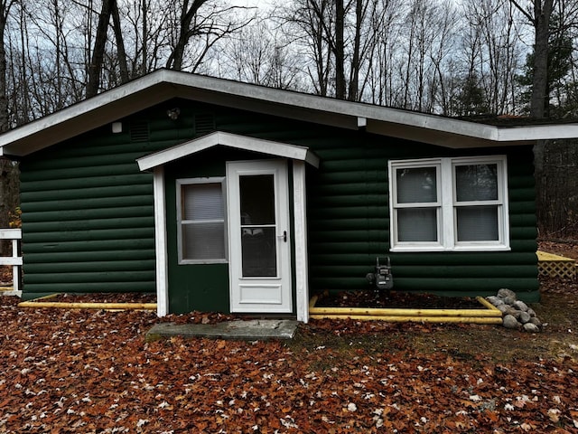 entrance to property featuring faux log siding