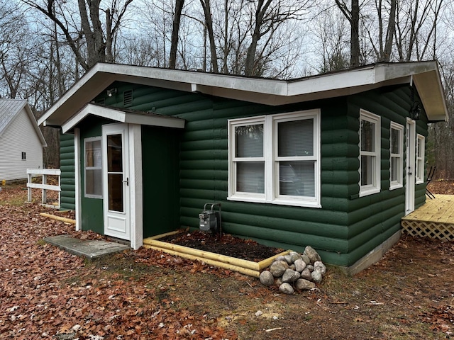 view of home's exterior with faux log siding