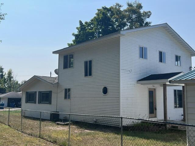 view of property exterior featuring fence