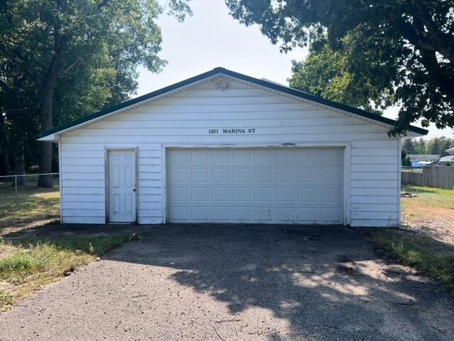 detached garage featuring fence