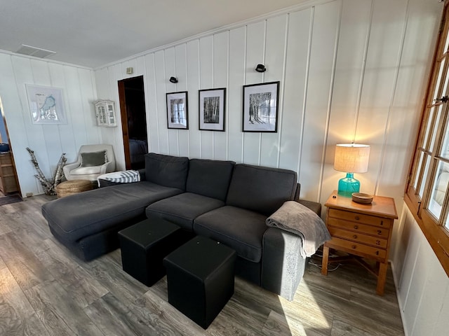 living room featuring visible vents and wood finished floors