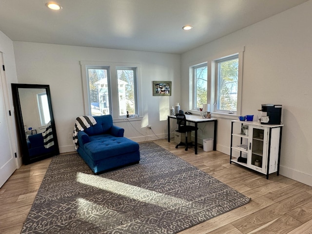 office space featuring recessed lighting, wood finished floors, baseboards, and a healthy amount of sunlight