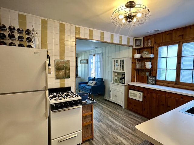 kitchen featuring visible vents, dark wood-type flooring, open shelves, white appliances, and light countertops