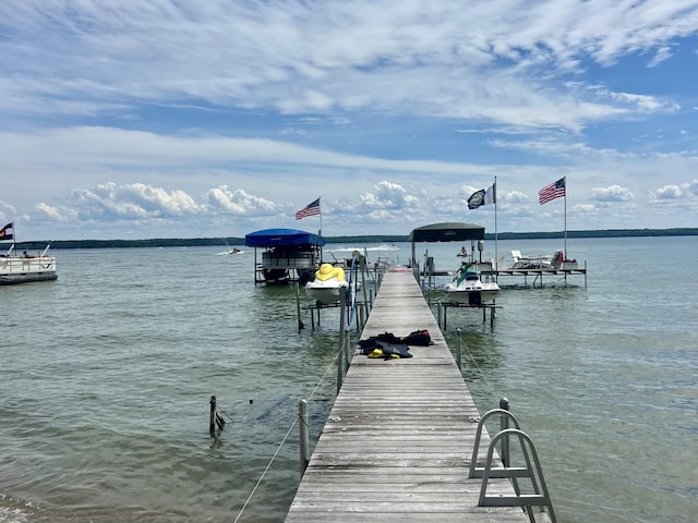 view of dock featuring boat lift and a water view