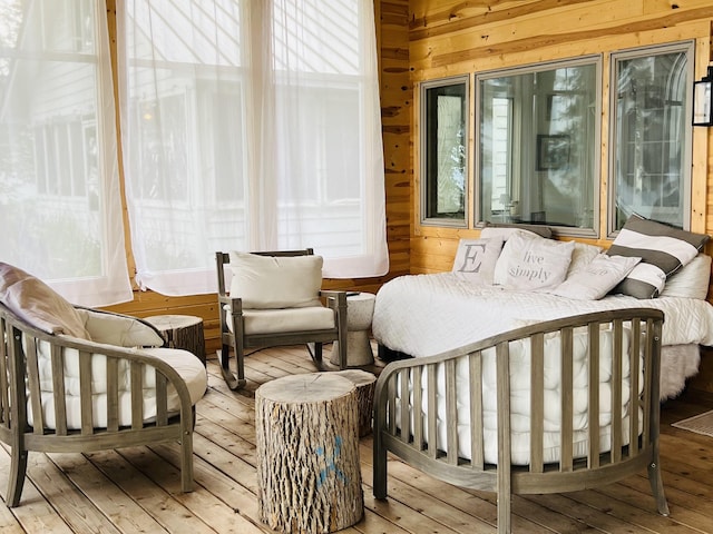 bedroom featuring wood-type flooring and wooden walls