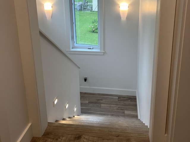 stairs with baseboards and wood finished floors