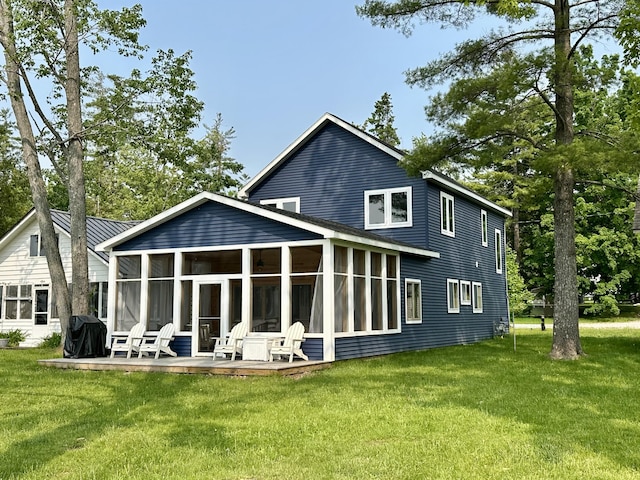 4288 Long Point Dr, Cheboygan, MI 49721 - rear view of house featuring a sunroom and a yard