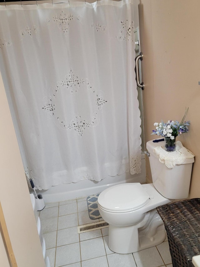 full bathroom featuring tile patterned floors, visible vents, toilet, and shower / bath combination with curtain