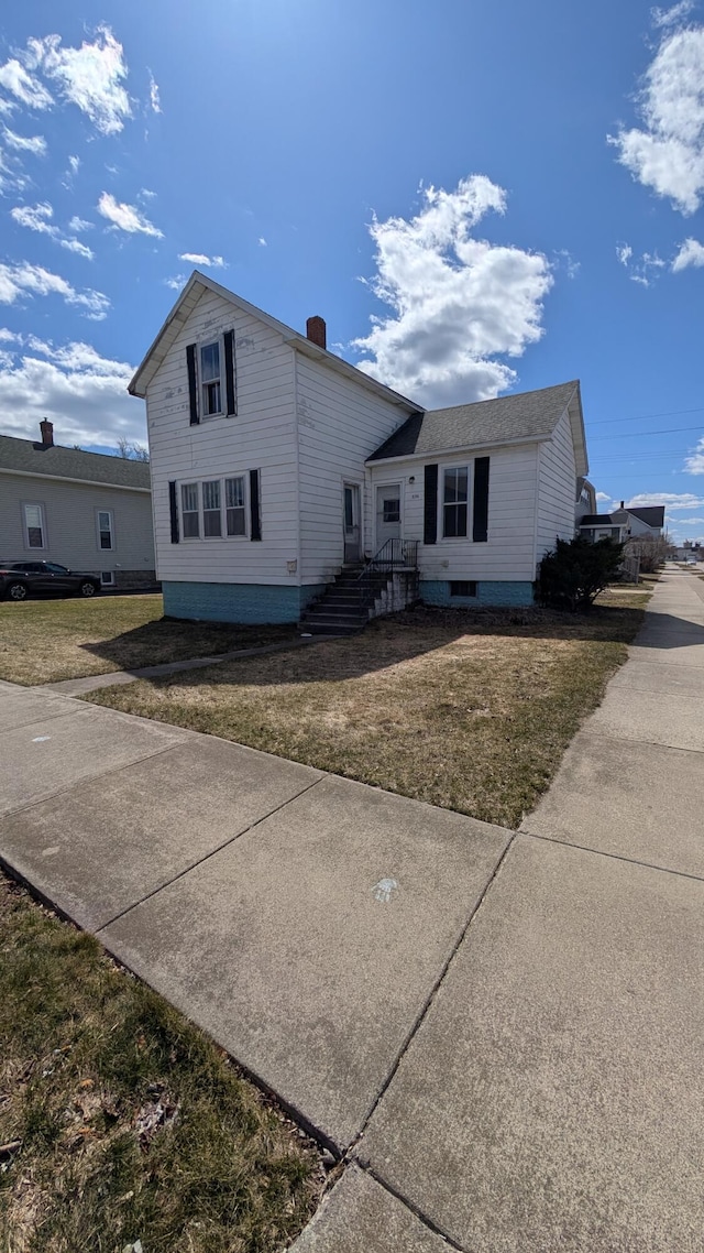 334 W Lake St, Alpena, MI 49707 - view of front of home featuring a front yard and a chimney