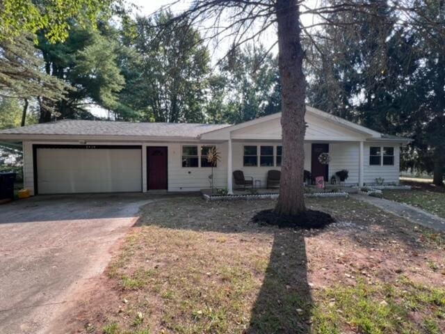 ranch-style home featuring concrete driveway and an attached garage