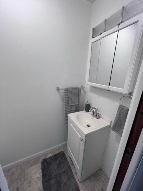 bathroom with vanity and baseboards