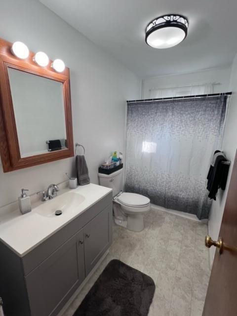 full bath featuring vanity and toilet