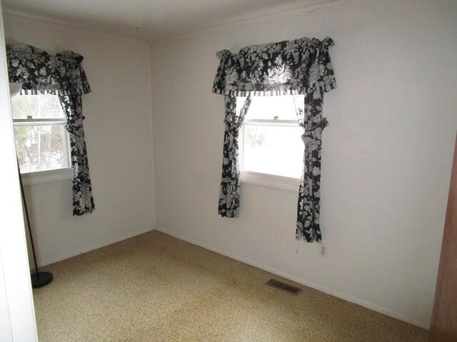 spare room featuring visible vents and baseboards