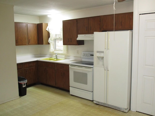 kitchen with a sink, extractor fan, white appliances, light countertops, and light floors