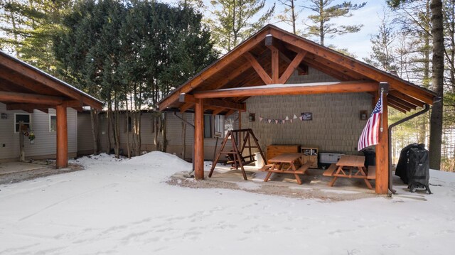 view of snow covered rear of property