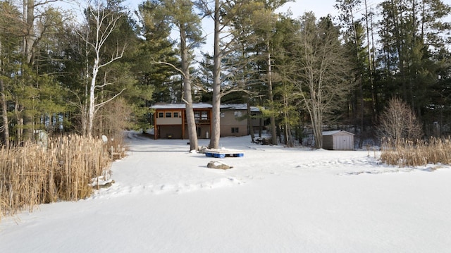 view of front facade featuring an outbuilding and a storage unit