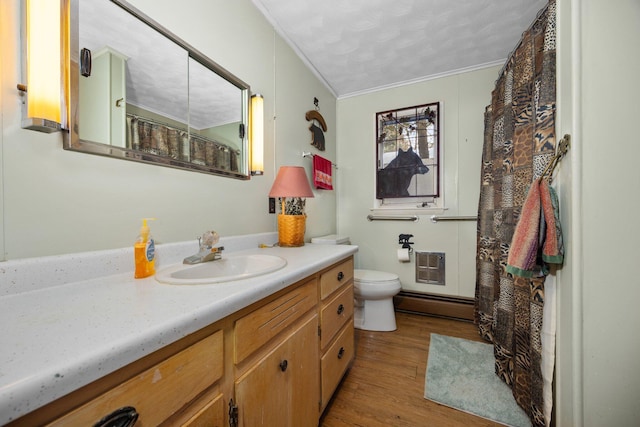 full bathroom with crown molding, a baseboard heating unit, toilet, wood finished floors, and vanity