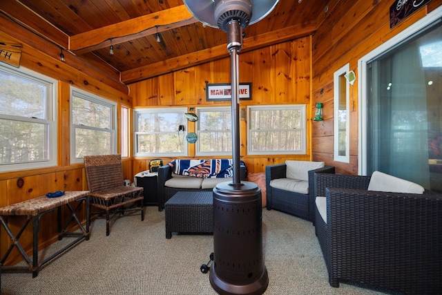 sunroom / solarium featuring vaulted ceiling with beams and wood ceiling