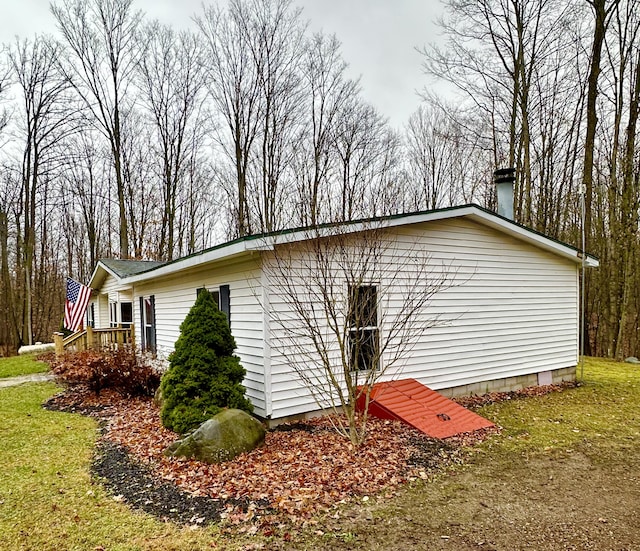 view of side of home with a lawn