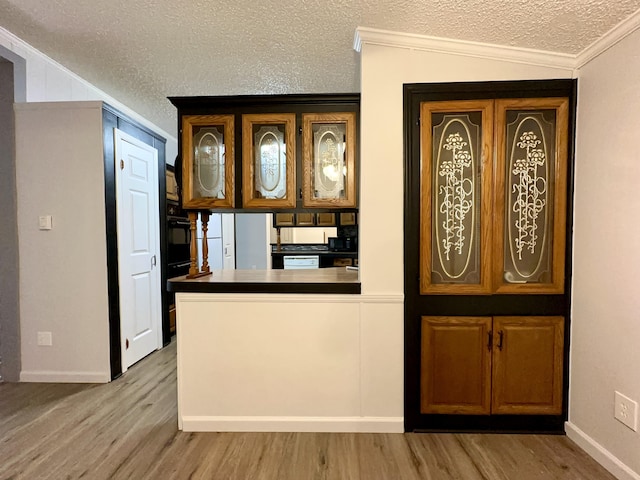 kitchen with white fridge, a textured ceiling, light wood-type flooring, and ornamental molding