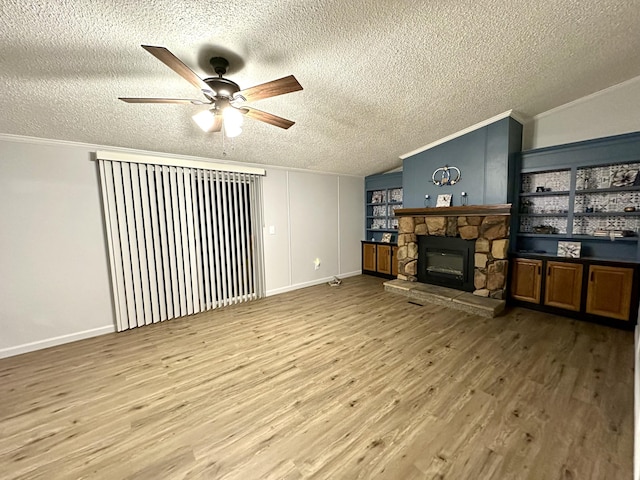 living area featuring a fireplace, vaulted ceiling, wood finished floors, and ornamental molding