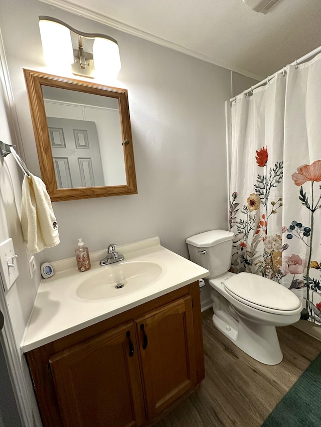 full bath with toilet, vanity, a shower with curtain, and wood finished floors