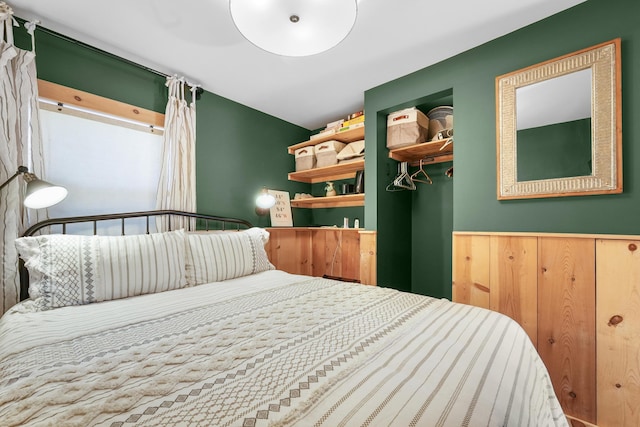 bedroom featuring wainscoting