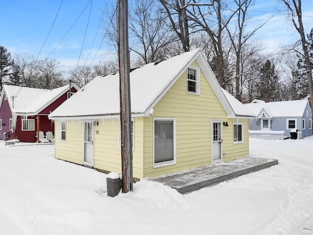 view of snow covered back of property