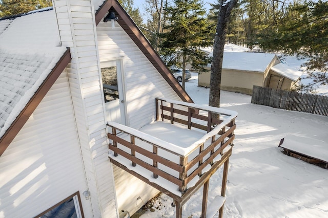 snow covered deck with fence