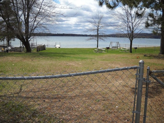 view of yard with a water view and fence