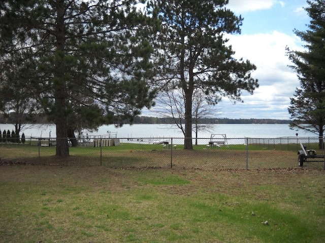 view of yard with fence and a water view