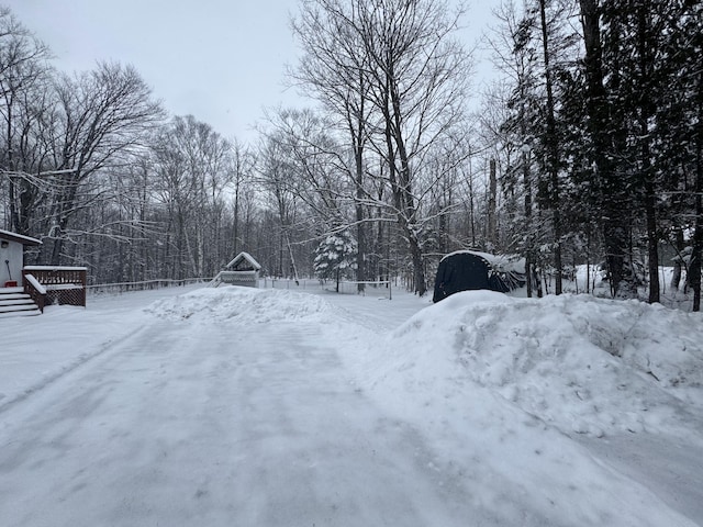 yard covered in snow featuring a deck