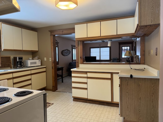 kitchen with light countertops, white appliances, and light floors