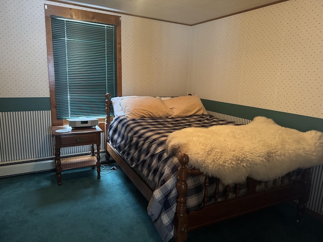 bedroom with a baseboard heating unit, wallpapered walls, and carpet floors